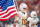 ARLINGTON, TX - DECEMBER 02: Texas Longhorns quarterback Arch Manning (16) runs on the field carrying the American flag before the Big 12 Championship game between the Texas Longhorns and the Oklahoma State Cowboys on December 02, 2023 at AT&T Stadium in Arlington, TX. (Photo by Chris Leduc/Icon Sportswire via Getty Images)