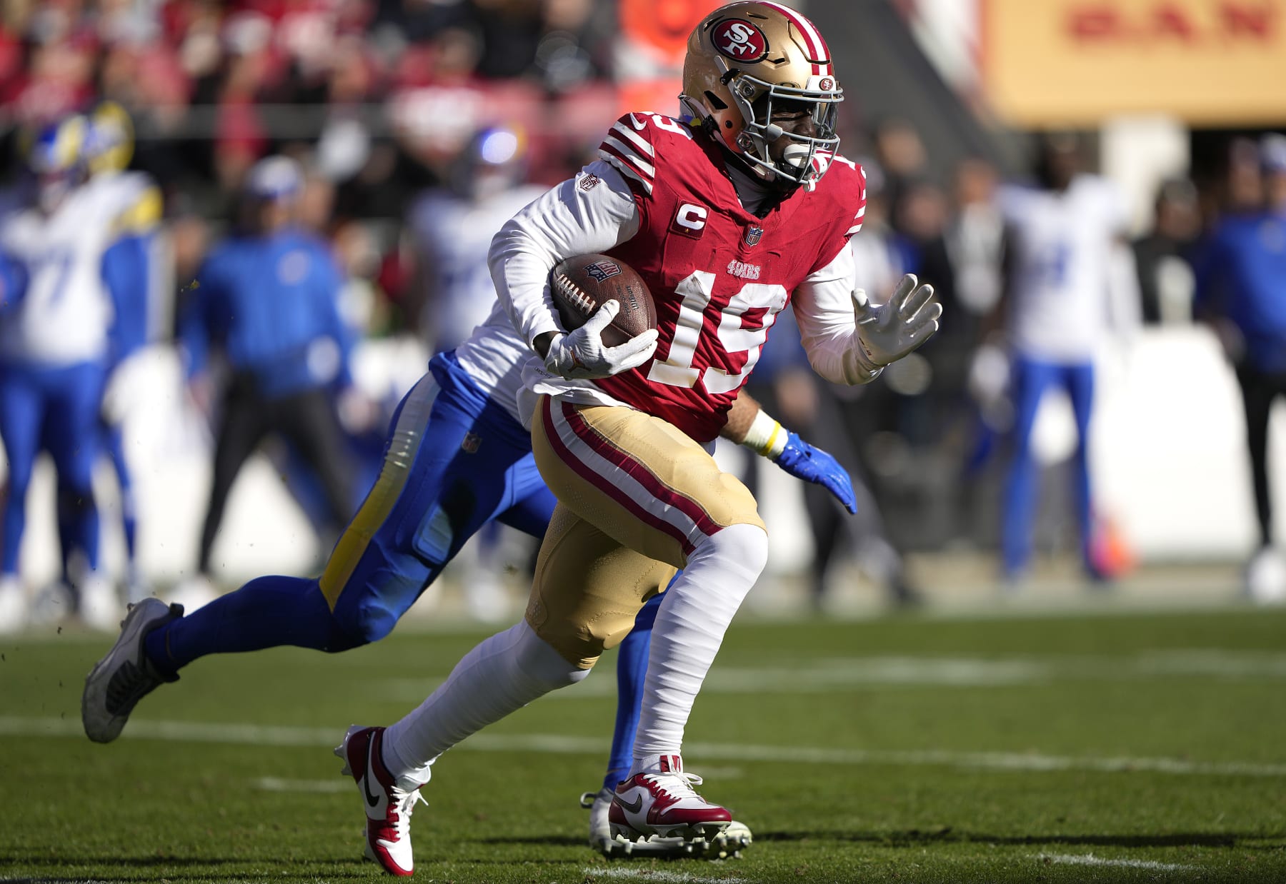 SANTA CLARA, CALIFORNIA - JANUARY 07: Deebo Samuel #19 of the San Francisco 49ers runs with the ball after catching a pass against the Los Angeles Rams during the first quarter of an NFL football game at Levi's Stadium on January 07, 2024 in Santa Clara, California. (Photo by Thearon W. Henderson/Getty Images)