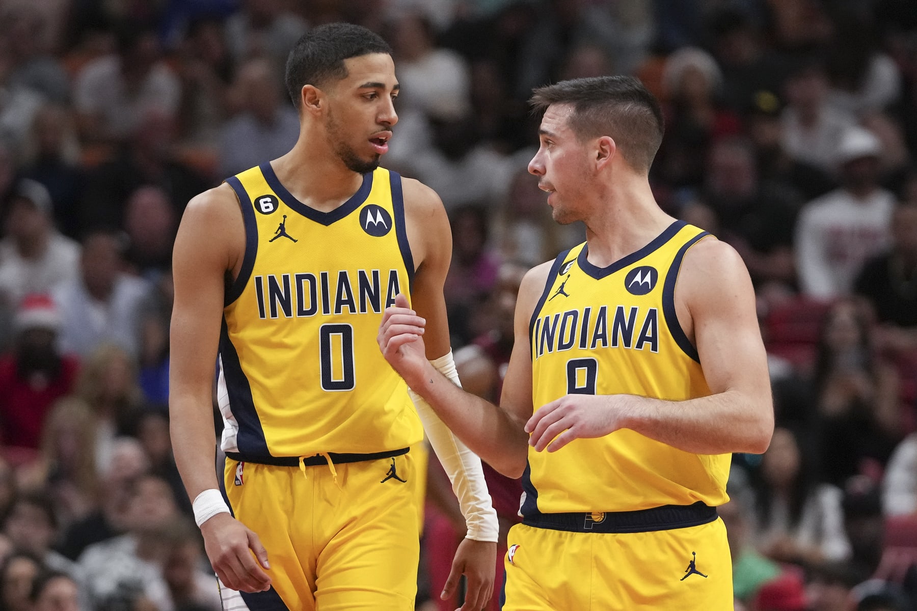 MIAMI, FLORIDA - DECEMBER 23: Tyrese Haliburton #0 of the Indiana Pacers talks with T.J. McConnell #9 during a free throw attempt during the second half against the Miami Heat at FTX Arena on December 23, 2022 in Miami, Florida. NOTE TO USER: User expressly acknowledges and agrees that,  by downloading and or using this photograph,  User is consenting to the terms and conditions of the Getty Images License Agreement. (Photo by Eric Espada/Getty Images)