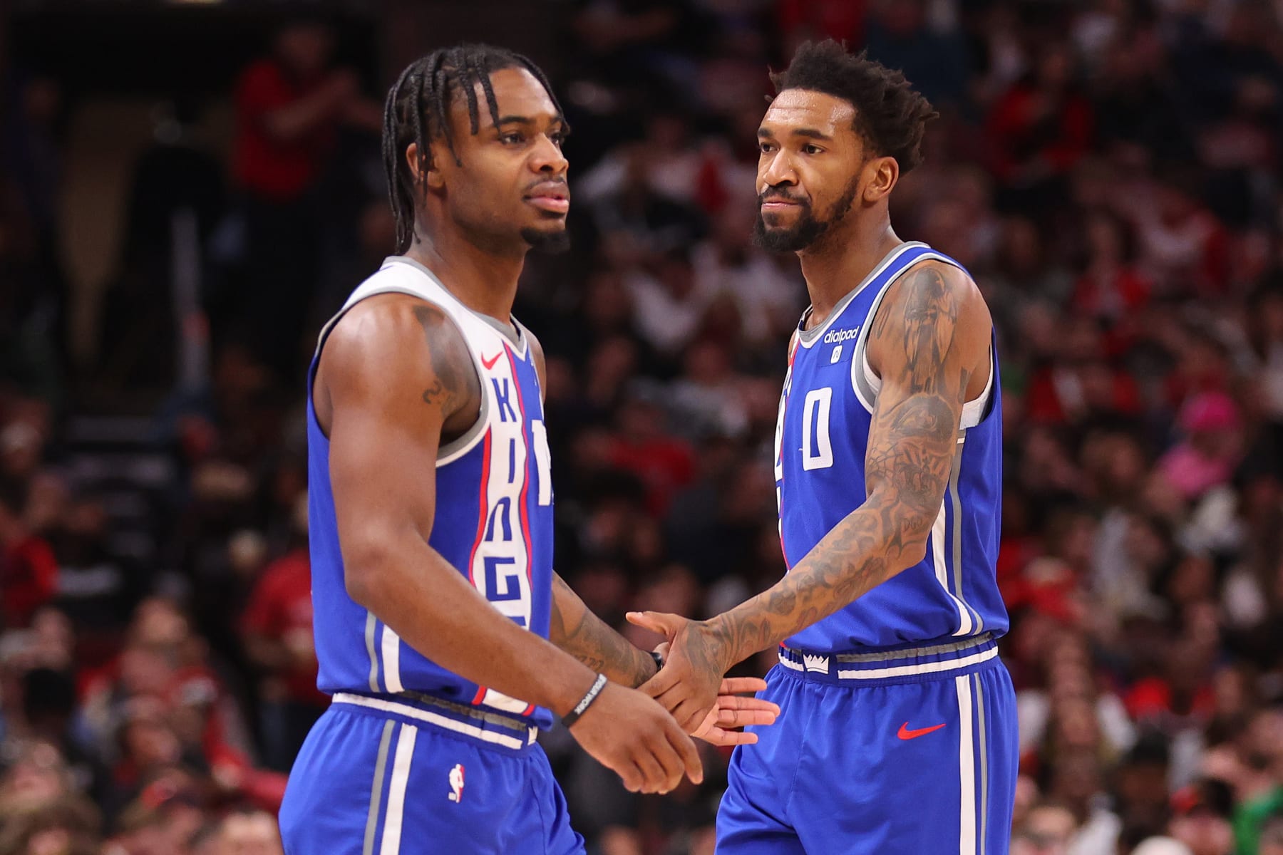 CHICAGO, ILLINOIS - FEBRUARY 03: Davion Mitchell #15 and Malik Monk #0 of the Sacramento Kings celebrate a basket against the Chicago Bulls during the first half at the United Center on February 03, 2024 in Chicago, Illinois. NOTE TO USER: User expressly acknowledges and agrees that, by downloading and or using this photograph, User is consenting to the terms and conditions of the Getty Images License Agreement.  (Photo by Michael Reaves/Getty Images)