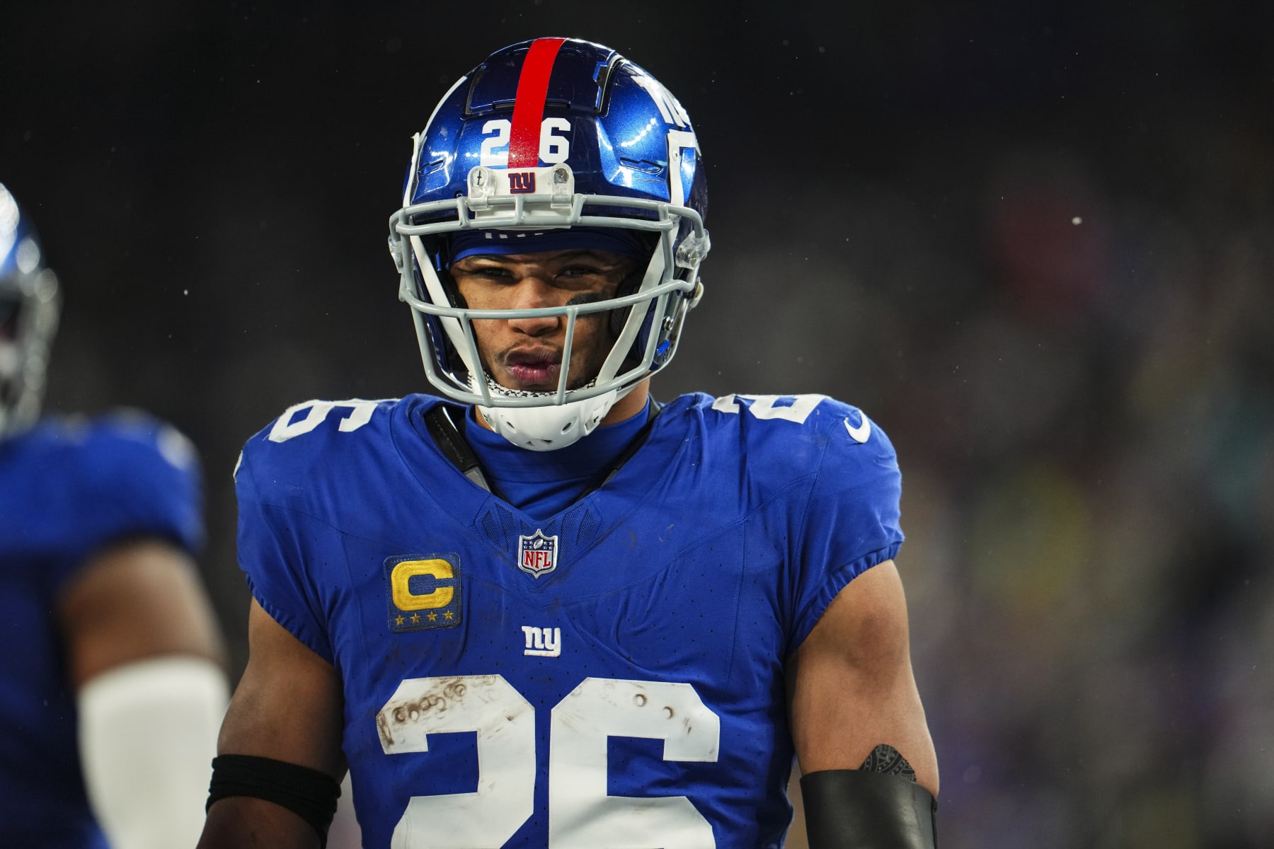 EAST RUTHERFORD, NJ - JANUARY 07: Saquon Barkley #26 of the New York Giants looks on from the field during an NFL football game against the Philadelphia Eagles at MetLife Stadium on January 7, 2024 in East Rutherford, New Jersey. (Photo by Cooper Neill/Getty Images)