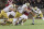 PALO ALTO, CA - NOVEMBER 25: Sam Roush #86 of the Stanford Cardinal is tackled by Thomas Harper #13, Rylie Mills #99, Xavier Watts #0, and Gabriel Rubio #97 of the Notre Dame Fighting Irish during a college football game on November 25, 2023 at Stanford Stadium in Palo Alto, California. (Photo by David Madison/Getty Images)