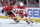 CHICAGO, ILLINOIS - MARCH 26: Oliver Kylington #58 of the Calgary Flames approaches the puck ahead of Landon Slaggert #84 of the Chicago Blackhawks in the third period at the United Center on March 26, 2024 in Chicago, Illinois. (Photo by Bill Smith/NHLI via Getty Images)