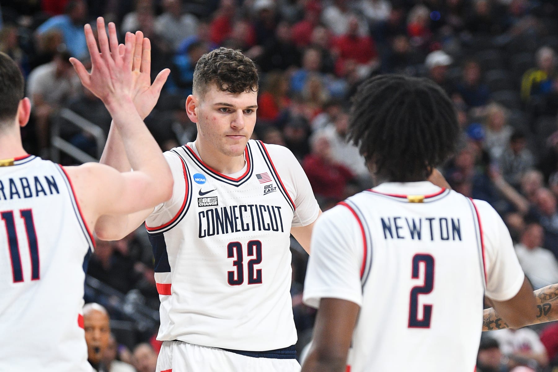 LAS VEGAS, NV - MARCH 24: UConn Huskies center Donovan Clingan (32) gets a high five from UConn Huskies forward Alex Karaban (11) and UConn Huskies guard Tristen Newton (2) during the NCAA Division I Men's Championship Sweet Sixteen round basketball game between the Arkansas Razorbacks and the UConn Huskies on March 24, 2023 at T-Mobile Arena in Las Vegas, NV. (Photo by Brian Rothmuller/Icon Sportswire via Getty Images)