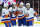 RALEIGH, NORTH CAROLINA - APRIL 30: Mike Reilly #2 of the New York Islanders celebrates with teammates Bo Horvat #14, Brock Nelson #29 and Mathew Barzal #13 after scoring a power play goal against the Carolina Hurricanes during the first period in Game Five of the First Round of the 2024 Stanley Cup Playoffs at PNC Arena on April 30, 2024 in Raleigh, North Carolina. (Photo by Grant Halverson/Getty Images)