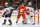 CALGARY, ALBERTA - APRIL 14: Mikael Backlund #11 of the Calgary Flames skates against Sean Durzi #50 of the Arizona Coyotes at the Scotiabank Saddledome on April 14, 2024 in Calgary, Alberta. (Photo by Gerry Thomas/NHLI via Getty Images)