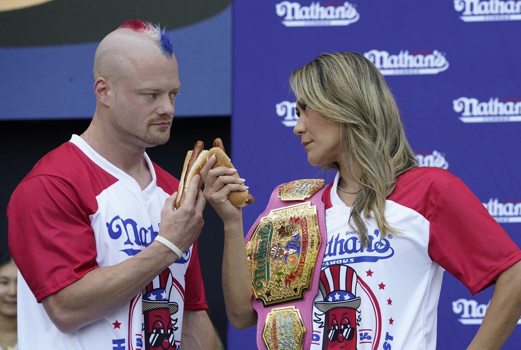 (L-R Nick Wehry and Miki Sudo do a stare-down during a weigh-in for the 2024 Nathan's Famous Fourth of July International Hot Dog-Eating Championship at Hudson Yards in New York City on July 3, 2024. The contest will take place in Coney Island, New York on July 4, 2024. (Photo by TIMOTHY A. CLARY / AFP) (Photo by TIMOTHY A. CLARY/AFP via Getty Images)