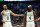 Dallas, TX - June 14: Boston Celtics guard Derrick White and guard Jrue Holiday gesture towards the bench during the second quarter in Game 4 of the 2024 NBA Finals. (Photo by Danielle Parhizkaran/The Boston Globe via Getty Images)