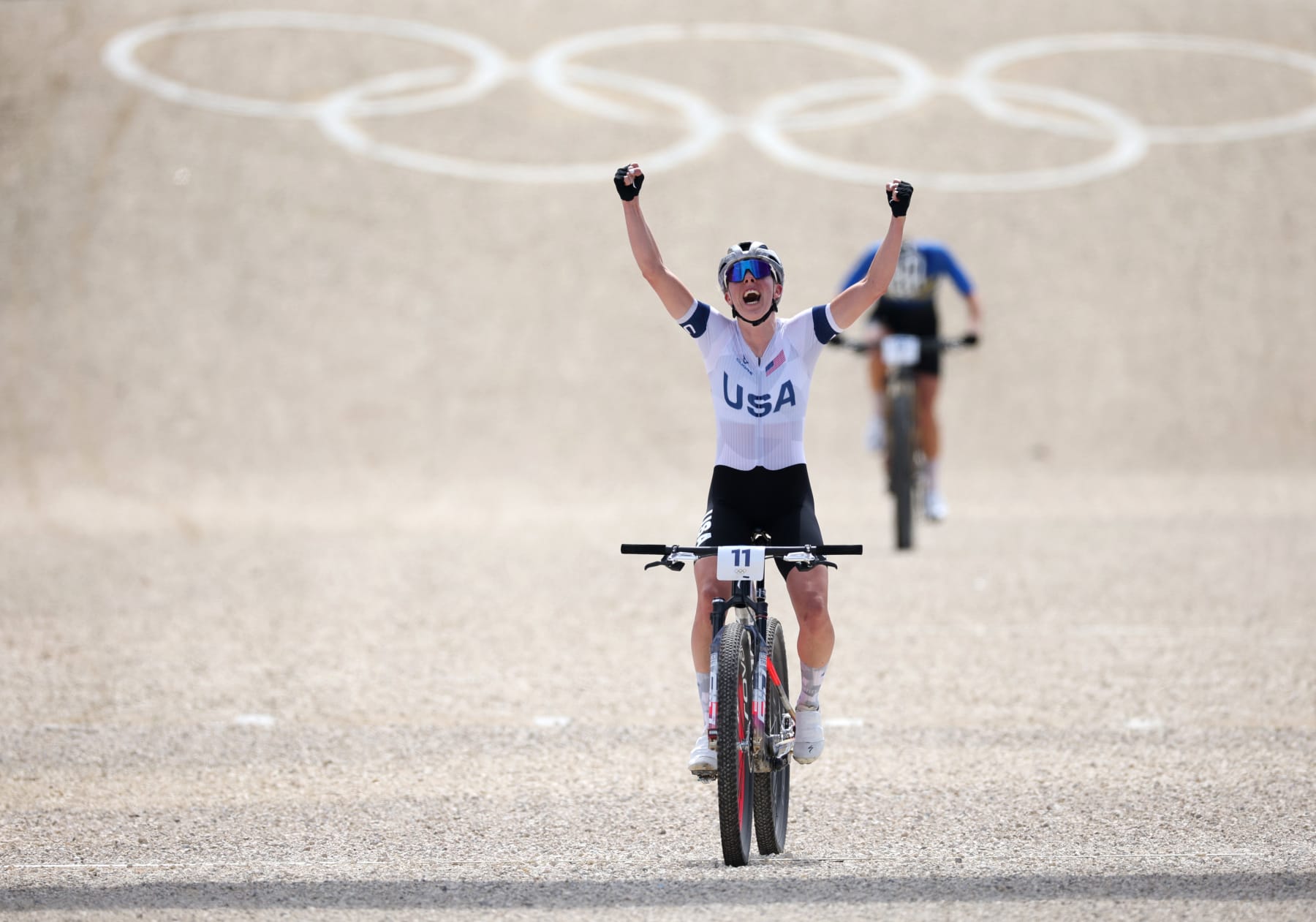 ELANCOURT, FRANCE - JULY 28: Haley Batten of Physique of workers United States celebrates winning silver as she crosses the kill line through the Ladies folks’s Obnoxious-Country Biking Mountain Bike Gold Medal lumber on day two of the Olympic Games Paris 2024 at Elancourt Hill on July 28, 2024 in Elancourt, France. (Photo by Jared C. Tilton/Getty Pictures)
