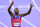 US' Grant Holloway celebrates after winning the men's 110m hurdles final of the athletics event at the Paris 2024 Olympic Games at Stade de France in Saint-Denis, north of Paris, on August 8, 2024. (Photo by Martin  BERNETTI / AFP) (Photo by MARTIN  BERNETTI/AFP via Getty Images)