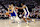 SACRAMENTO, CALIFORNIA - APRIL 16: Stephen Curry #30 of the Golden State Warriors is guarded by Keegan Murray #13 and De'Aaron Fox #5 of the Sacramento Kings in the first quarter during the Play-In Tournament at Golden 1 Center on April 16, 2024 in Sacramento, California. NOTE TO USER: User expressly acknowledges and agrees that, by downloading and or using this photograph, User is consenting to the terms and conditions of the Getty Images License Agreement. (Photo by Ezra Shaw/Getty Images)