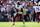 BALTIMORE, MARYLAND - OCTOBER 13: Jayden Daniels #5 of the Washington Commanders looks to pass against the Baltimore Ravens during the second quarter at M&T Bank Stadium on October 13, 2024 in Baltimore, Maryland. (Photo by Patrick Smith/Getty Images)
