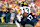 CHAMPAIGN, IL - OCTOBER 19: Michigan Wolverines Quarterback Jack Tuttle (13) fumbles the ball during the college football game between the Michigan Wolverines and the Illinois Fighting Illini on October 19, 2024, at Memorial Stadium, in Champaign, Illinois. (Photo by Michael Allio/Icon Sportswire via Getty Images)