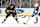 BOSTON, MA - JANUARY 18: Boston Bruins center Trent Frederic (11) shovels the puck past Colorado Avalanche center Ross Colton (20) during a game between the Boston Bruins and the Colorado Rapids on January 18, 2024, at TD Garden in Boston, Massachusetts. (Photo by Fred Kfoury III/Icon Sportswire via Getty Images)