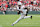 CHICAGO, ILLINOIS - NOVEMBER 16: Jeremiah Smith #4 of the Ohio State Buckeyes runs with the ball after a reception against the Northwestern Wildcats during the first half at Wrigley Field on November 16, 2024 in Chicago, Illinois. (Photo by Michael Reaves/Getty Images)