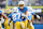 INGLEWOOD, CALIFORNIA - NOVEMBER 10: Justin Herbert #10 of the Los Angeles Chargers hands the ball off to J.K. Dobbins #27 in the first quarter of a game against the Tennessee Titans at SoFi Stadium on November 10, 2024 in Inglewood, California. (Photo by Harry How/Getty Images)