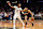 PHOENIX, ARIZONA - DECEMBER 03: Devin Booker #1 of the Phoenix Suns drives against Stephon Castle #5 of the San Antonio Spurs during the first half of the Emirates NBA Cup game at Footprint Center on December 03, 2024 in Phoenix, Arizona. Booker scored his 15,000th career point on this play. NOTE TO USER: User expressly acknowledges and agrees that, by downloading and or using this photograph, User is consenting to the terms and conditions of the Getty Images License Agreement.  (Photo by Chris Coduto/Getty Images)