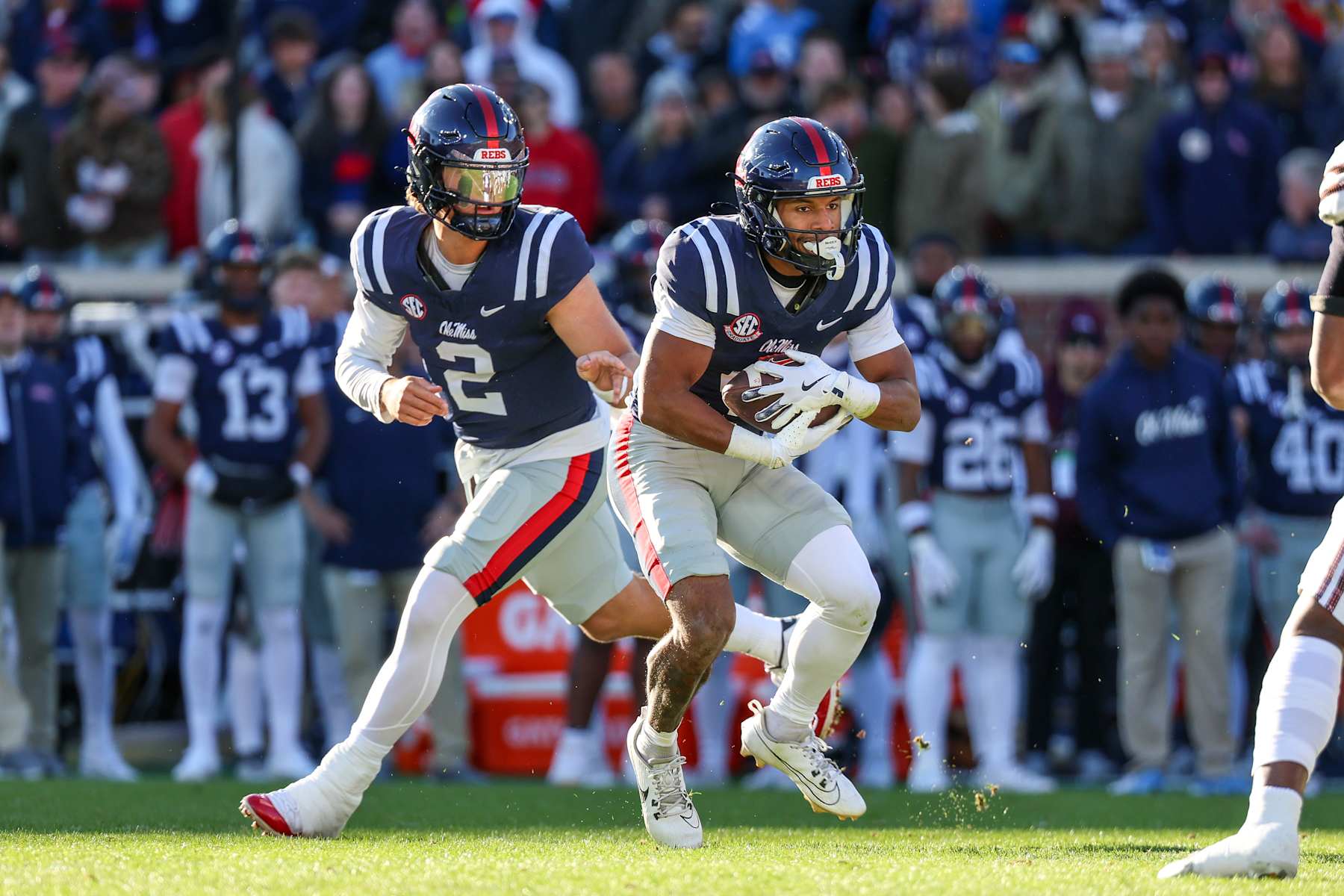 Football OXFORD, MISSISSIPPI - NOVEMBER 29: Jaxson Dart #2 of the Mississippi Rebels hands the ball to Micah Davis #4 during the first half against the Mississippi State Bulldogs at Vaught-Hemingway Stadium on November 29, 2024 in Oxford, Mississippi. (Photo by Wes Hale/Getty Images)