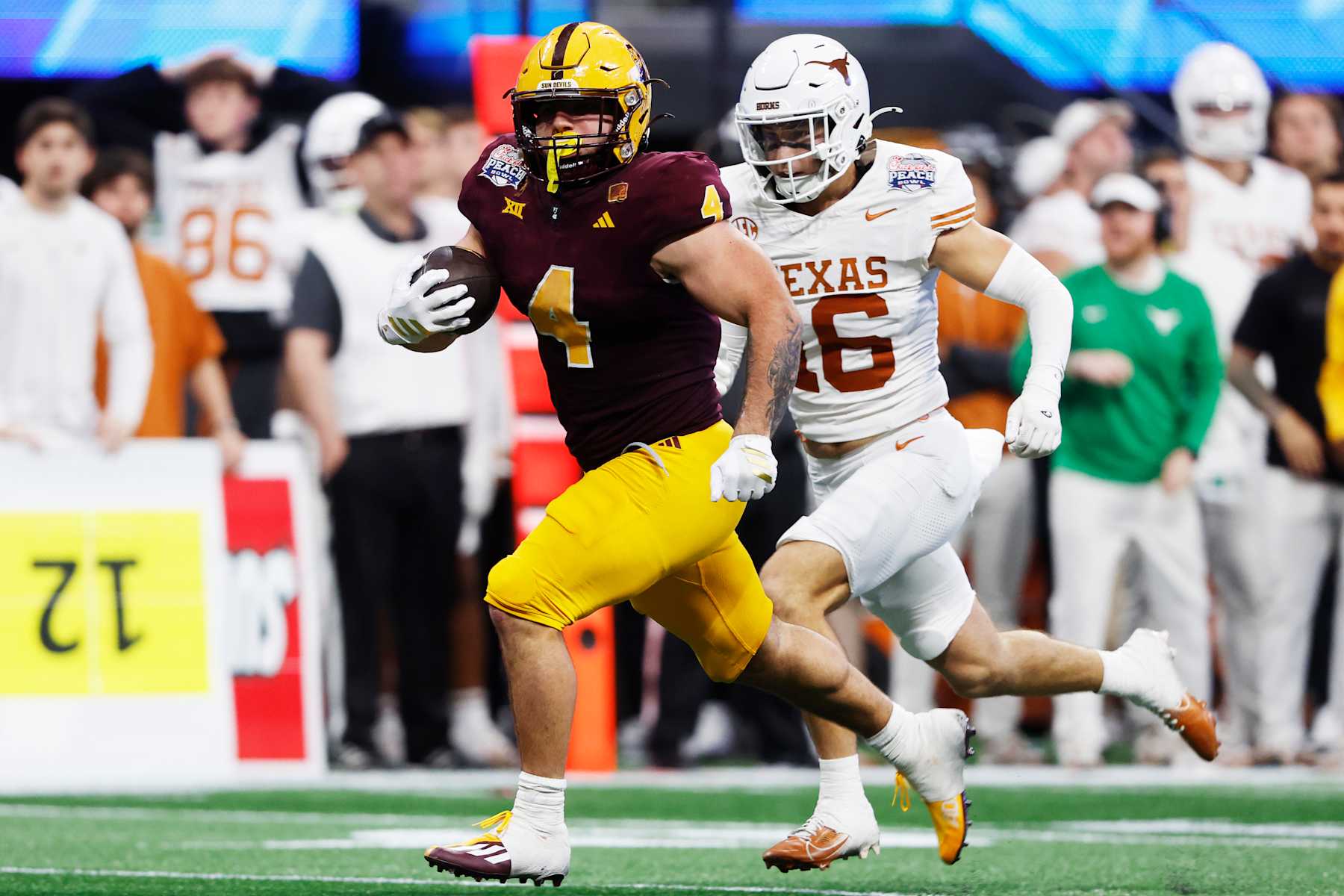 Football Football ATLANTA, GEORGIA - JANUARY 01: Cam Skattebo #4 of the Arizona State Sun Devils runs the ball during the third quarter against the Texas Longhorns in the Chick-fil-A Peach Bowl at Mercedes-Benz Stadium on January 01, 2025 in Atlanta, Georgia. (Photo by Butch Dill/Getty Images)