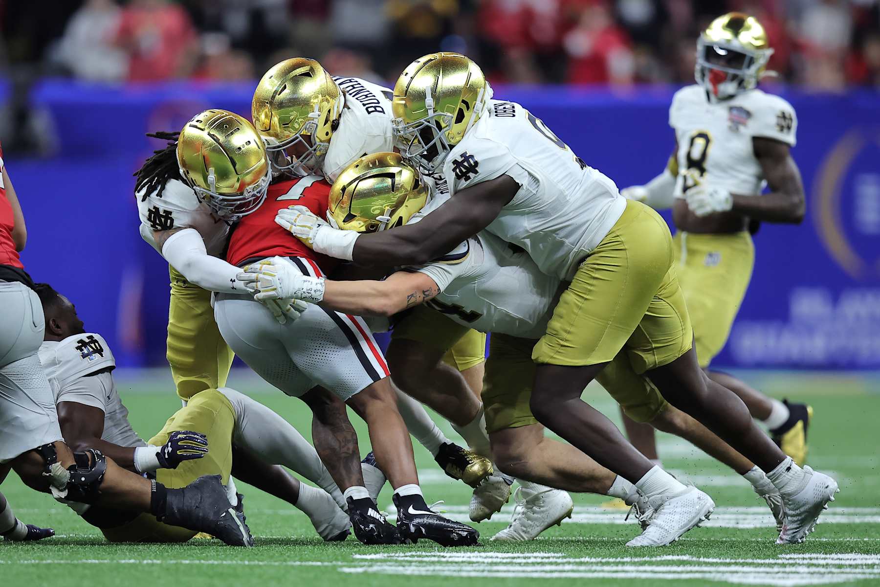 Football Football NEW ORLEANS, LOUISIANA - JANUARY 02: Trevor Etienne #1 of the Georgia Bulldogs is tackled by Notre Dame Fighting Irish players during the third quarter during the 91st Allstate Sugar Bowl at Caesars Superdome on January 02, 2025 in New Orleans, Louisiana. (Photo by Jonathan Bachman/Getty Images)