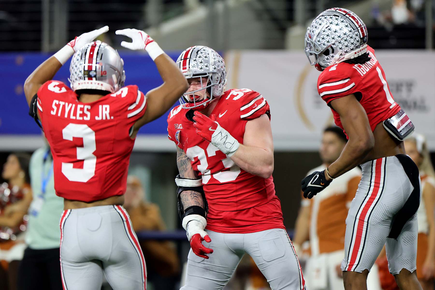 Football ARLINGTON, TEXAS - JANUARY 10: Jack Sawyer #33 of the Ohio State Buckeyes celebrates with teammates after scoring a touchdown in the fourth quarter against the Texas Longhorns during the Goodyear Cotton Bowl at AT&T Stadium on January 10, 2025 in Arlington, Texas. (Photo by Alex Slitz/Getty Images)