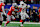 Texas' Ryan Wingo stiff-arms Ohio State's Denzel Burke