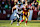 LANDOVER, MD - DECEMBER 22: Saquon Barkley #26 of the Philadelphia Eagles carries the ball against the Washington Commanders during the first half of the game at Northwest Stadium on December 22, 2024 in Landover, Maryland. (Photo by Scott Taetsch/Getty Images)