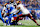 DETROIT, MICHIGAN - JANUARY 18: Linebacker Frankie Luvu #4 of the Washington Commanders recovers a fumble during the first half of an NFL football divisional playoff game against the Detroit Lions, at Ford Field on January 18, 2025 in Detroit, Michigan. (Photo by Brooke Sutton/Getty Images)