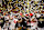 ATLANTA, GEORGIA - JANUARY 20: Head coach Ryan Day, Jack Sawyer #33 , and JT Tuimoloau #44 of the Ohio State Buckeyes hoist the trophy after beating the Notre Dame Fighting Irish 34-23 in the 2025 CFP National Championship at the Mercedes-Benz Stadium on January 20, 2025 in Atlanta, Georgia. (Photo by Carmen Mandato/Getty Images)