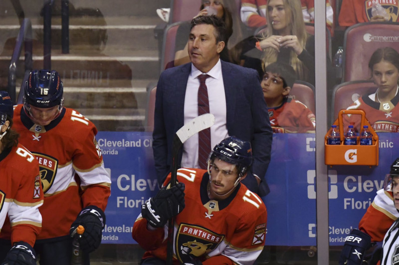 Florida Panthers interim coach Andrew Brunette, center, watches during the during the third period of the team's NHL hockey game against the Buffalo Sabres on Friday, April 8, 2022, in Sunrise, Fla. (AP Photo/Jim Rassol)