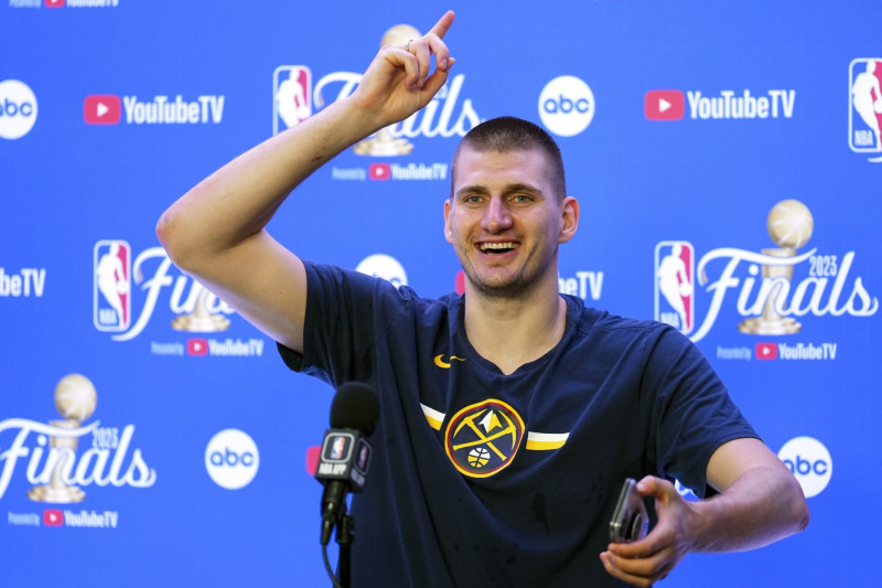 Denver Nuggets' Nikola Jokic talks to reporters after the team won the NBA Championship with a victory over the Miami Heat in Game 5 of basketball's NBA Finals, Monday, June 12, 2023, in Denver. (AP Photo/Jack Dempsey)