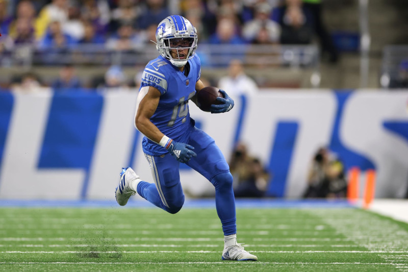 DETROIT, MICHIGAN - DECEMBER 11: Amon-Ra St. Brown #14 of the Detroit Lions runs with the ball during the first half against the Minnesota Vikings at Ford Field on December 11, 2022 in Detroit, Michigan. (Photo by Mike Mulholland/Getty Images)