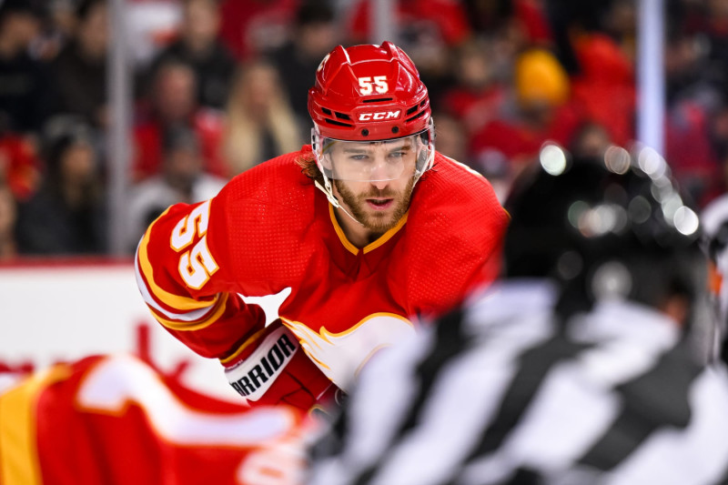 CALGARY, AB - MARCH 28: Calgary Flames Defenceman Noah Hanifin (55) gets ready for a face-off during the first period of an NHL game between the Calgary Flames and the Los Angeles Kings on March 28, 2023, at the Scotiabank Saddledome in Calgary, AB. (Photo by Brett Holmes/Icon Sportswire via Getty Images)