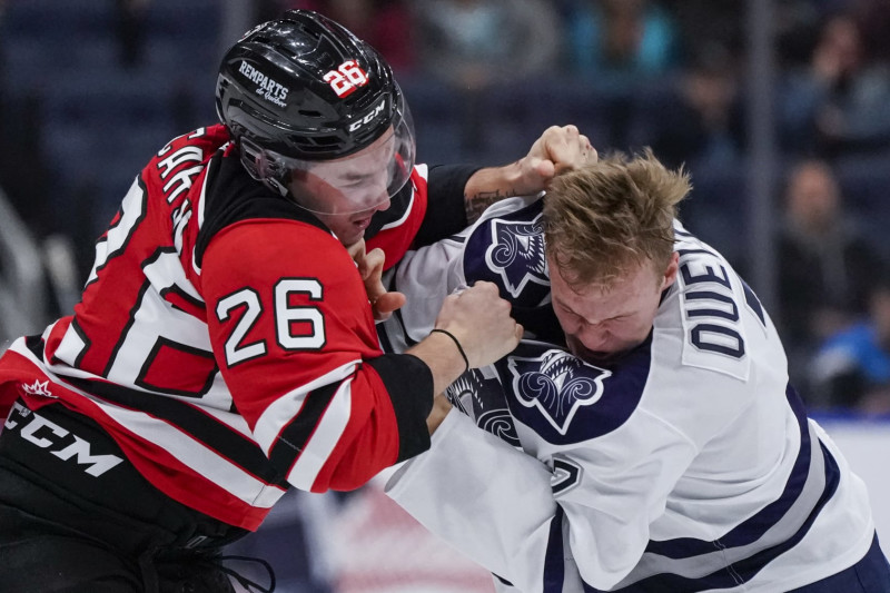 QUEBEC CITY, QC - OCTOBER 18:  Nathan Ouellet #7 of the Rimouski Oceanic and Thomas Caron #26 of the Quebec Remparts fight during their QMJHL hockey game at the Videotron Center on October 18, 2019 in Quebec City, Quebec, Canada. (Photo by Mathieu Belanger/Getty Images)