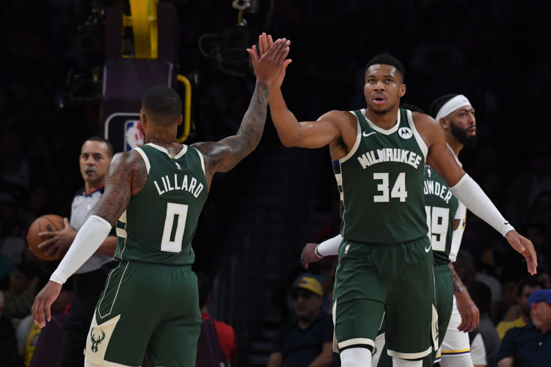 LOS ANGELES, CA - OCTOBER 15: Damian Lillard #0 high fives Giannis Antetokounmpo #34 of the Milwaukee Bucks during the preseason game on October 15, 2023 at Crypto.Com Arena in Los Angeles, California. NOTE TO USER: User expressly acknowledges and agrees that, by downloading and/or using this Photograph, user is consenting to the terms and conditions of the Getty Images License Agreement. Mandatory Copyright Notice: Copyright 2023 NBAE (Photo by Juan Ocampo/NBAE via Getty Images)