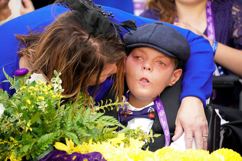 LEXINGTON, KENTUCKY - NOVEMBER 05: Leslie Dorman comforts her son Cody in the winner's circle after Cody's Wish won the Breeders' Cup Dirt Mile during the 2022 Breeders' Cup at Keeneland Race Course on November 05, 2022 in Lexington, Kentucky. (Photo by Dylan Buell/Getty Images)