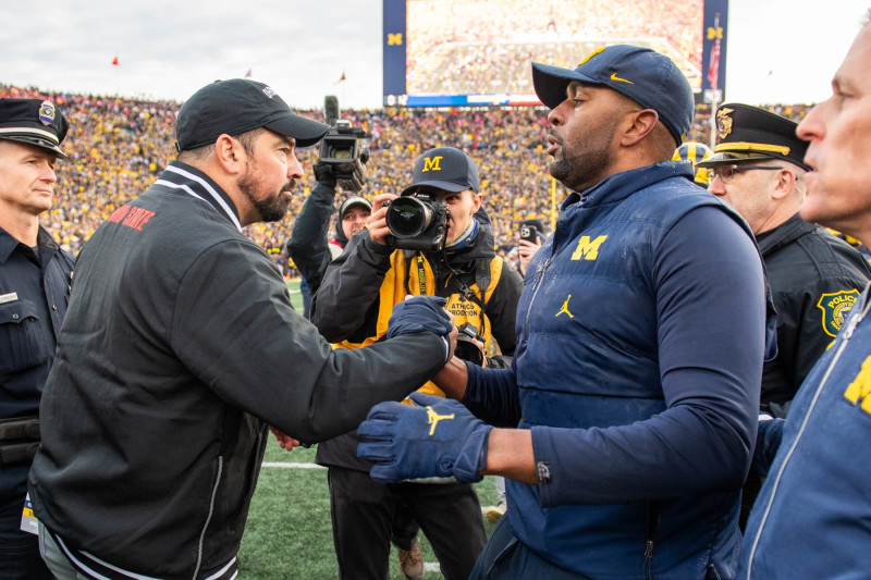 ANN ARBOR, MICHIGAN - NOVEMBER 25: Head Football Coaches Ryan Day (L) of the Ohio State Buckeyes and Sherrone Moore (R) of the Michigan Wolverines shake hands after a college football game at Michigan Stadium on November 25, 2023 in Ann Arbor, Michigan. The Michigan Wolverines won the game 30-24 to win the Big Ten East. (Photo by Aaron J. Thornton/Getty Images)