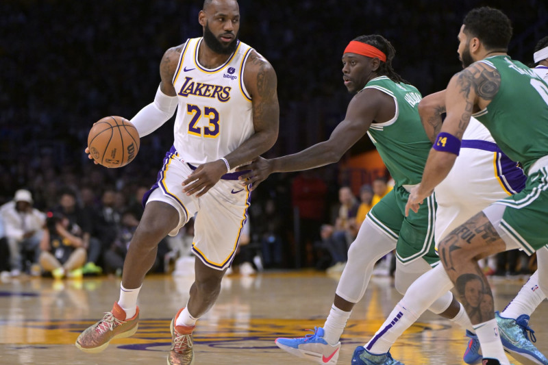 LOS ANGELES, CALIFORNIA - DECEMBER 25: LeBron James #23 of the Los Angeles Lakers drives past Jrue Holiday #4 of the Boston Celtics in the first half at Crypto.com Arena on December 25, 2023 in Los Angeles, California. NOTE TO USER: User expressly acknowledges and agrees that, by downloading and or using this photograph, User is consenting to the terms and conditions of the Getty Images License Agreement.(Photo by Jayne Kamin-Oncea/Getty Images)