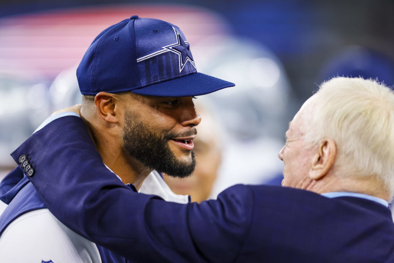 ARLINGTON, TX - AUGUST 26: Dallas Cowboys quarterback Dak Prescott (4) talks with Jerry Jones before the preseason game between the Dallas Cowboys and the Las Vegas Raiders on August 26, 2023 at AT&T Stadium in Arlington, Texas. (Photo by Matthew Pearce/Icon Sportswire via Getty Images)