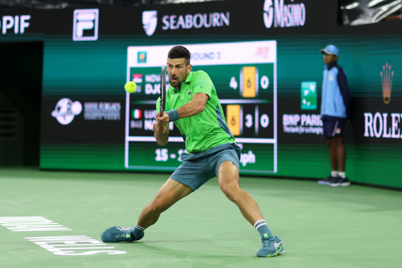 INDIAN WELLS, CALIFORNIA - MARCH 11:  Novak Djokovic of Serbia plays a backhand against Luca Nardi of Italy in their third round match during the BNP Paribas Open at Indian Wells Tennis Garden on March 11, 2024 in Indian Wells, California. (Photo by Clive Brunskill/Getty Images)