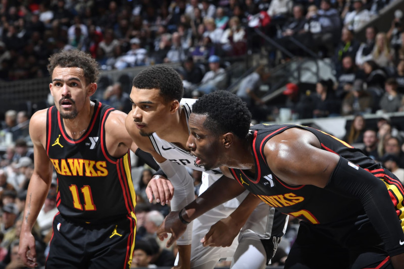 SAN ANTONIO, TX - NOVEMBER 30: Trae Young #11 of the Atlanta Hawks, Victor Wembanyama #1 of the San Antonio Spurs and Onyeka Okongwu #17 of the Atlanta Hawks wait for a rebound during the game on November 30, 2023 at the Frost Bank Center in San Antonio, Texas. NOTE TO USER: User expressly acknowledges and agrees that, by downloading and or using this photograph, user is consenting to the terms and conditions of the Getty Images License Agreement. Mandatory Copyright Notice: Copyright 2023 NBAE (Photos by Logan Riely/NBAE via Getty Images)