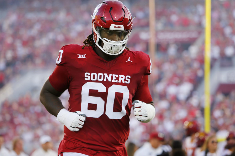 NORMAN, OKLAHOMA - SEPTEMBER 30:  Right tackle Tyler Guyton #60 of the Oklahoma Sooners runs onto the field for a game against the Iowa State Cyclones at Gaylord Family Oklahoma Memorial Stadium on September 30, 2023 in Norman, Oklahoma.  Oklahoma won 50-20.  (Photo by Brian Bahr/Getty Images)
