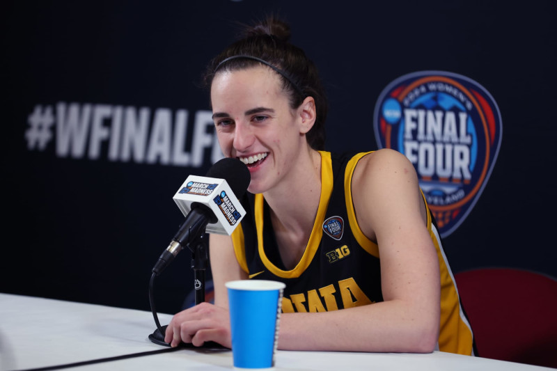 CLEVELAND, OHIO - APRIL 07: Caitlin Clark #22 of the Iowa Hawkeyes talks with the media after losing to the South Carolina Gamecocks in the 2024 NCAA Women's Basketball Tournament National Championship at Rocket Mortgage FieldHouse on April 07, 2024 in Cleveland, Ohio. South Carolina beat Iowa 87-75. (Photo by Steph Chambers/Getty Images)