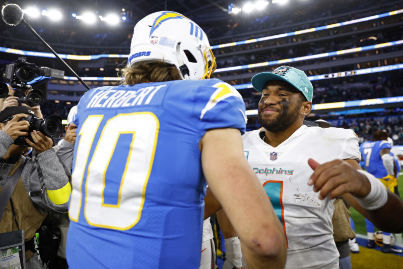 INGLEWOOD, CALIFORNIA - DECEMBER 11: Justin Herbert #10 of the Los Angeles Chargers hugs Tua Tagovailoa #1 of the Miami Dolphins during a game  at SoFi Stadium on December 11, 2022 in Inglewood, California. (Photo by Ronald Martinez/Getty Images)