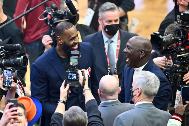 CLEVELAND, OHIO - FEBRUARY 20: Michael Jordan and LeBron James interact after the presentation of the NBA 75th Anniversary Team during the 2022 NBA All-Star Game at Rocket Mortgage Fieldhouse on February 20, 2022 in Cleveland, Ohio. NOTE TO USER: User expressly acknowledges and agrees that, by downloading and or using this photograph, User is consenting to the terms and conditions of the Getty Images License Agreement. (Photo by Jason Miller/Getty Images)