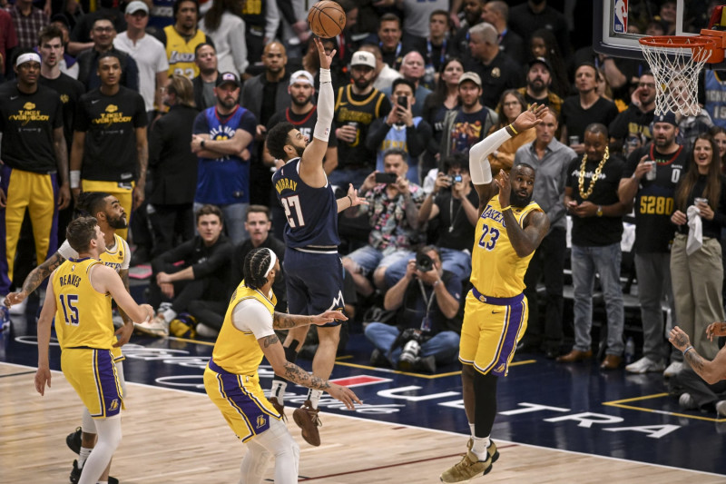 DENVER, CO - APRIL 29: Jamal Murray (27) of the Denver Nuggets hits a floater over LeBron James (23) of the Los Angeles Lakers during the first quarter at Ball Arena in Denver, Colorado on Monday, April 29, 2024. (Photo by AAron Ontiveroz/The Denver Post)