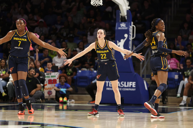ARLINGTON, TEXAS - MAY 03: Caitlin Clark #22 of the Indiana Fever celebrates a first half three pointer with Allya Boston #7 and Tami Fagbenle #14 while playing the Dallas Wings at College Park Center on May 03, 2024 in Arlington, Texas. (Photo by Gregory Shamus/Getty Images)