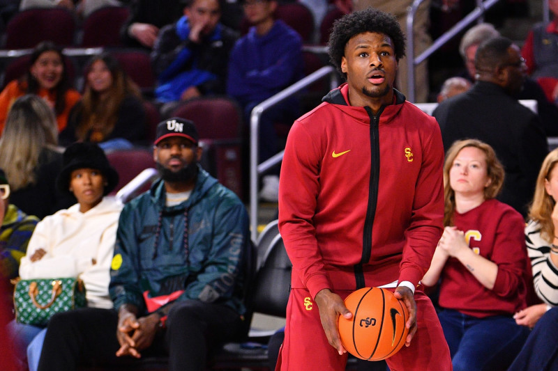 LOS ANGELES, CA - JANUARY 10: USC Trojans guard Bronny James (6) warms up as his parents Lebron James and Savannah James look on before the college basketball game between the Washington State Cougars and the USC Trojans on January 10, 2024 at Galen Center in Los Angeles, CA. (Photo by Brian Rothmuller/Icon Sportswire via Getty Images)