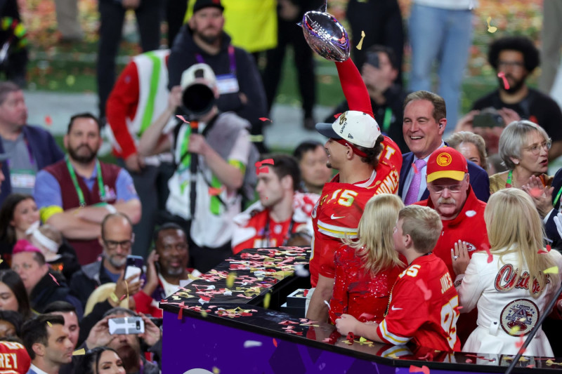 LAS VEGAS, NEVADA - FEBRUARY 11: Quarterback Patrick Mahomes #15 of the Kansas City Chiefs holds up the Vince Lombardi Trophy as head coach Andy Reid looks on as the Chiefs celebrates their 25-22 overtime victory over the San Francisco 49ers in Super Bowl LVIII at Allegiant Stadium on February 11, 2024 in Las Vegas, Nevada. (Photo by Ethan Miller/Getty Images)