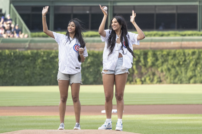 CHICAGO, ILLINOIS - MAY 21: Angel Reese and Kamilla Cardoso of the Chicago Sky throw out a ceremonial first pitch before a game between the Atlanta Braves and Chicago Cubs at Wrigley Field on May 21, 2024 in Chicago, Illinois. (Photo by Griffin Quinn/Getty Images)